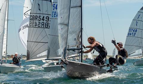 mid shot of sailors during a multiclass dinghy racing 