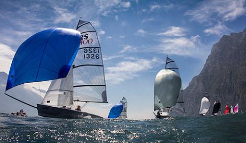 wide shot of multiclass sailing fleet with sails fully blown